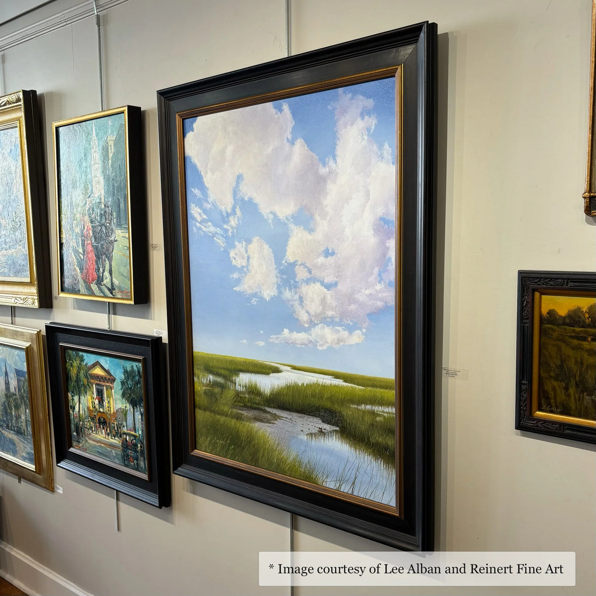 Realist marsh painting by Lee Alban in a wide black and gold frame, exhibited at Reinert Fine Art.